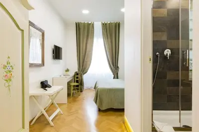 a small room with a bed and a shower at Relais Calamatta in Rome