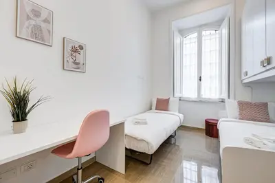 a small room with a desk and a bed at FaMa - Mecenate 3BR & 2BA in Rome