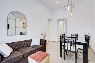 a living room with a couch and a table at FaMa - Mecenate 3BR & 2BA in Rome