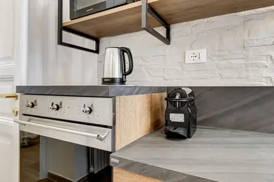 a kitchen with a coffee maker on the counter at FaMa - Mecenate 3BR & 2BA in Rome