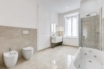 a bathroom with a tub and a toilet and a sink at FaMa - Mecenate 3BR & 2BA in Rome