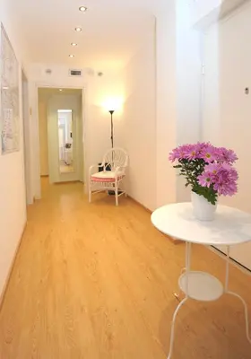 a room with a table with flowers on it at Holiday Home Roma in Rome