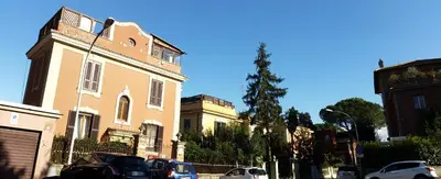a group of buildings on a street with cars parked at Holiday Home Roma in Rome