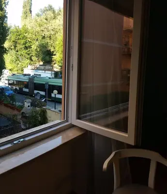 a window with a view of a train through it at Holiday Home Roma in Rome