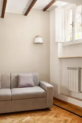 a living room with a couch and a window at Navona Square in Rome