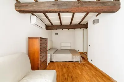a bedroom with a bed and a couch in a room at Navona Square in Rome