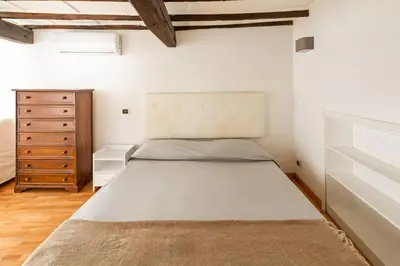 a bedroom with a large bed and a dresser at Navona Square in Rome