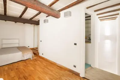 a bedroom with white walls and wooden ceilings at Navona Square in Rome