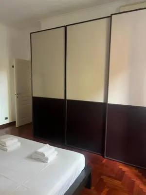 a room with a white bed and a large glass wall at Incontro tra Oriente e Occidente in Rome