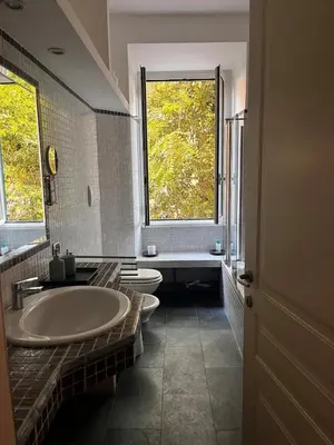 a bathroom with two sinks and a large window at Incontro tra Oriente e Occidente in Rome