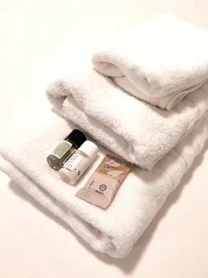 a pile of towels with products on top of it at Elegant Studio at Vatican Museum in Rome