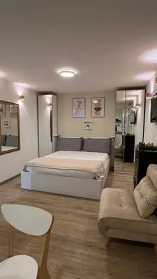 a bedroom with a large bed and a couch at Elegant Studio at Vatican Museum in Rome