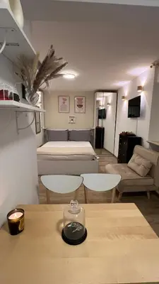 a room with a room with two beds and a table at Elegant Studio at Vatican Museum in Rome
