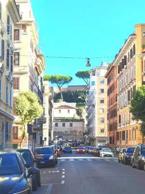 a busy city street with cars parked on the street at Elegant Studio at Vatican Museum in Rome