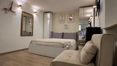 a bedroom with a bed and a mirror and a couch at Elegant Studio at Vatican Museum in Rome