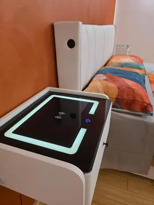 a bed with a tablet on it next to a bed at San Pietro Station 2 in Rome
