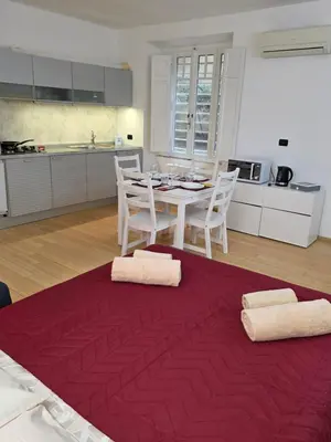 a kitchen and dining room with a table and chairs at San Pietro Station 2 in Rome