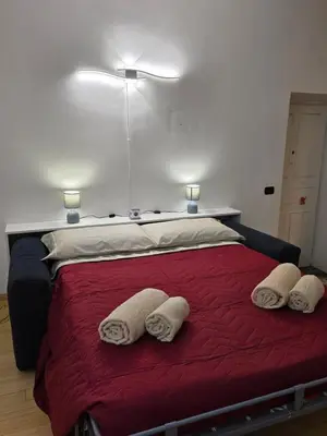 a bedroom with a bed with two white towels on it at San Pietro Station 2 in Rome