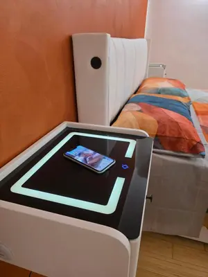a bed with a tablet next to a bed at San Pietro Station 2 in Rome