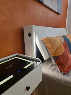 a bedroom with a bed and a desk with a tablet at San Pietro Station 2 in Rome