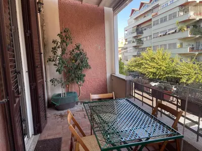 a balcony with a table and chairs and a building at Domus Oleandri - WelcomeToRhome in Rome