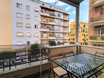 a balcony with a table and chairs and a building at Domus Oleandri - WelcomeToRhome in Rome
