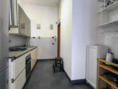 a small kitchen with a stove and a refrigerator at Domus Oleandri - WelcomeToRhome in Rome
