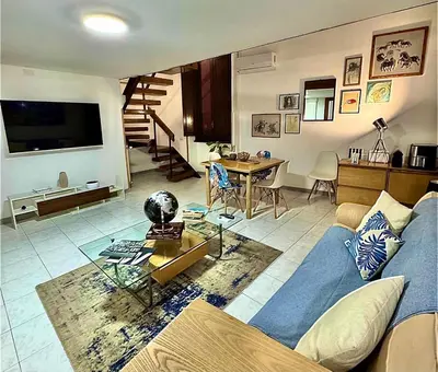 a living room with a blue couch and a table at Casa Kevisco in Rome