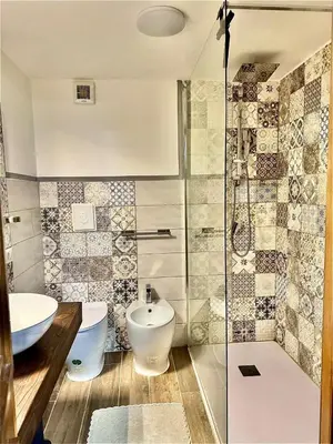 a bathroom with a toilet and a sink and a shower at Casa Kevisco in Rome