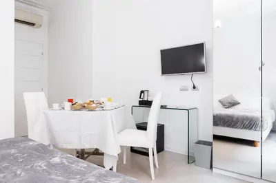 a dining room with a table and a bed at Vatican Grand Suite in Rome