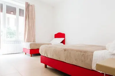 a bedroom with two beds and a window at Vatican Grand Suite in Rome