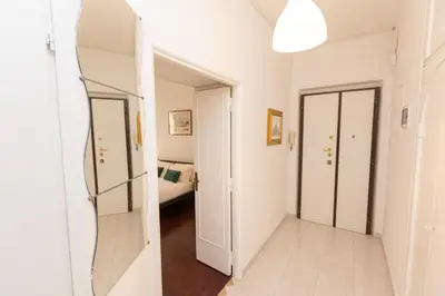 a hallway with a mirror and a bedroom at Vatican Museum Family Apartment in Rome
