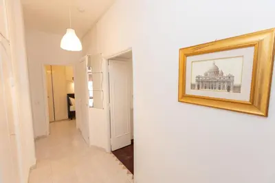 a hallway with a picture of a building on the wall at Vatican Museum Family Apartment in Rome