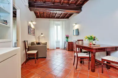 a kitchen and living room with a table and chairs at Cancelleriadieci in Rome