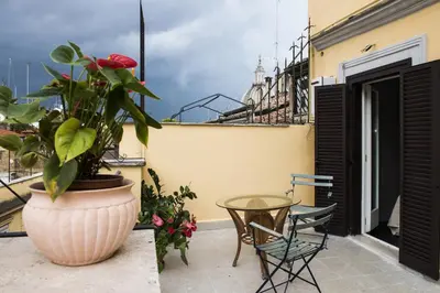 a patio with a plant and a table and chairs at Cancelleriadieci in Rome