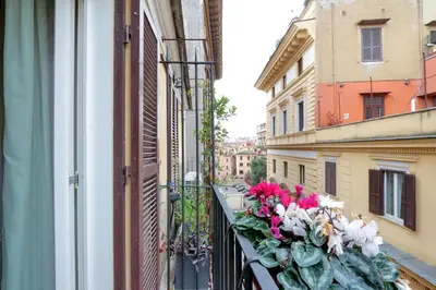 a balcony with pink and white flowers on a building at Cancelleriadieci in Rome