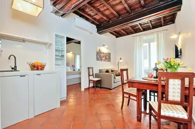 a kitchen and living room with a table and chairs at Cancelleriadieci in Rome