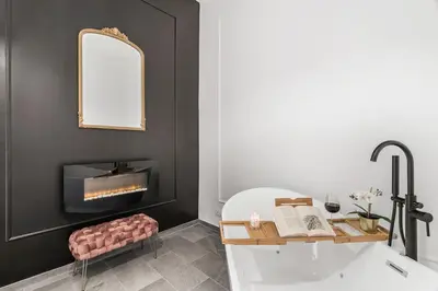 a bathroom with a bath tub and a fireplace at 4 bedrooms, luxury 5 minutes from the Colosseum Jacuzzi in Rome
