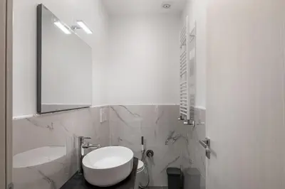 a bathroom with a toilet and a sink and a mirror at 4 bedrooms, luxury 5 minutes from the Colosseum Jacuzzi in Rome