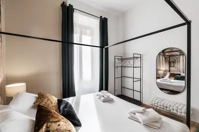 a bedroom with a large bed and a mirror at 4 bedrooms, luxury 5 minutes from the Colosseum Jacuzzi in Rome