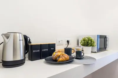 a counter with a coffee maker and a plate of croissants at 4 bedrooms, luxury 5 minutes from the Colosseum Jacuzzi in Rome