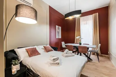 a hotel room with a bed and a table at 4 bedrooms, luxury 5 minutes from the Colosseum Jacuzzi in Rome
