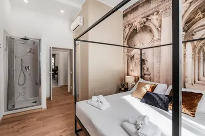 a bedroom with a four poster bed and a walk in shower at 4 bedrooms, luxury 5 minutes from the Colosseum Jacuzzi in Rome