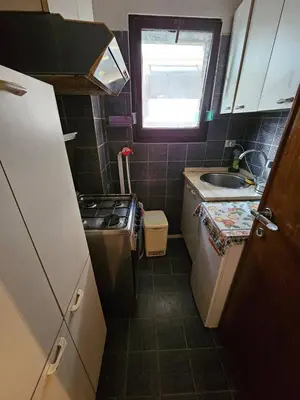 a small kitchen with a sink and a stove at La Perla in Rome