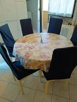 a table with a table cloth on it with chairs at La Perla in Rome