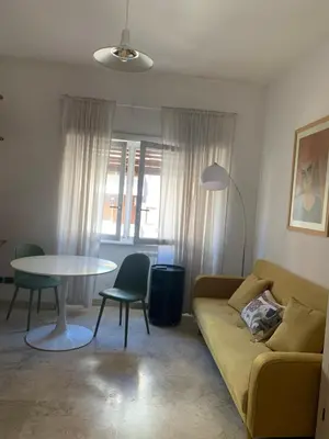 a living room with a couch and a table at Appartamento Eataly in Rome