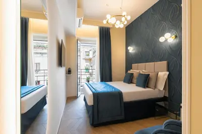 a hotel room with two beds and a window at Lussuosa casa zona esquilino in Rome