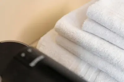 a stack of white towels sitting on top of a counter at Lussuosa casa zona esquilino in Rome
