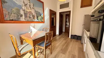 a dining room with a wooden table and chairs at Il Segreto del Borgo Vaticano in Rome