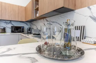 a tray with wine glasses on a kitchen counter at Dimora delle Vittorie - Vaticano in Rome